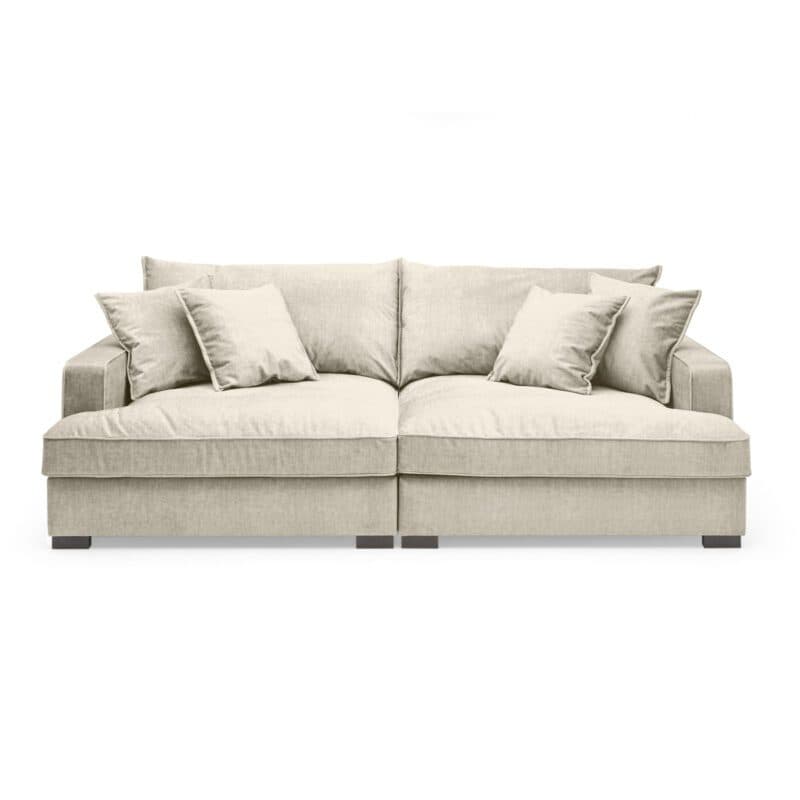 Trendstore Haidi Megasofa in Bezug Vogue creme mit zwei Rückenkissen und vier Zierkissen.