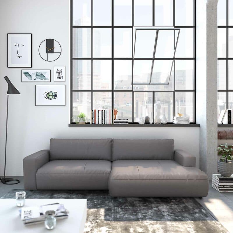 Musterring Lucia Ledersofa mit Bezug Puro in Schwarz und Ottomane links in frontaler Ansicht