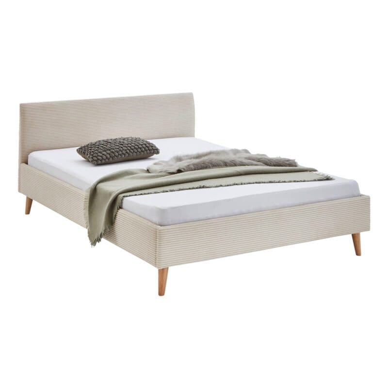 Meise Wicki Polsterbett mit Bezug aus Cord in Beige - seitliche Ansicht mit Dekoration