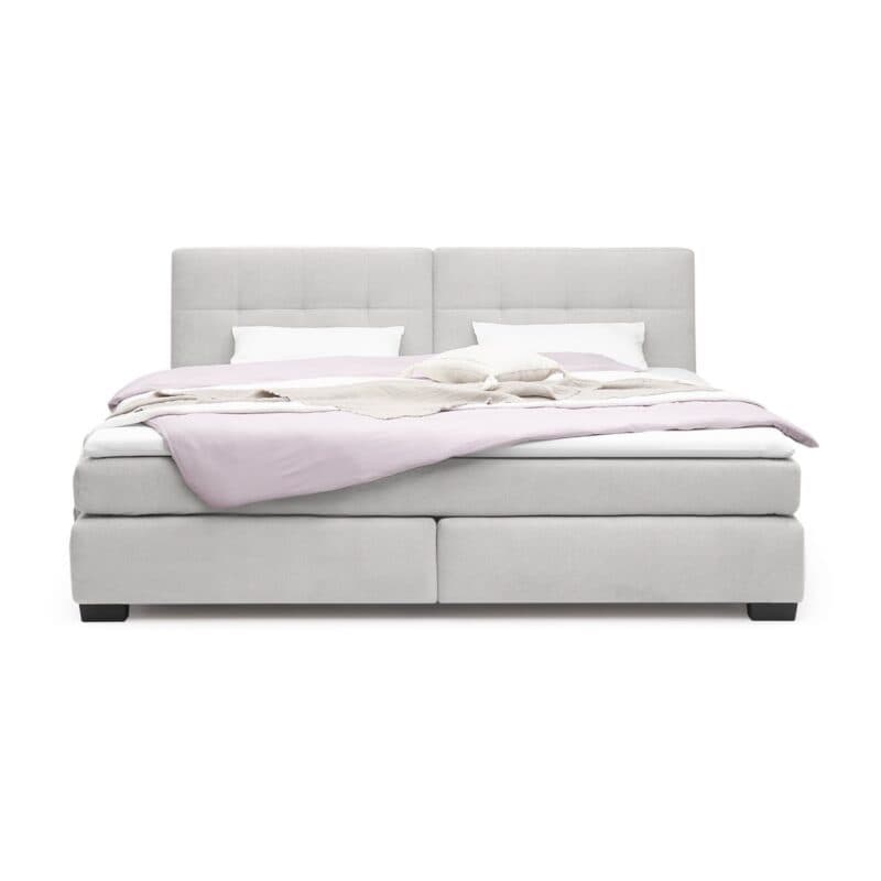 Trendstore Jila Boxspringbett in Bezug Cord beige - Liegefläche 240 x 200 cm - Frontansicht mit Deko